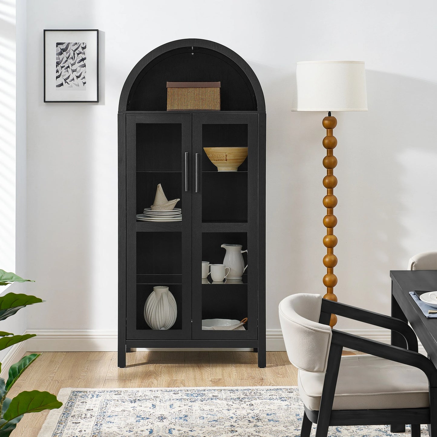 Blackarchedglassdisplaycabinetinbrightdiningroom_pairedwithwoodenbeadfloorlampandmoderndiningfurniture_d4d82a09-8673-4425-8e79-2c6995904aa7