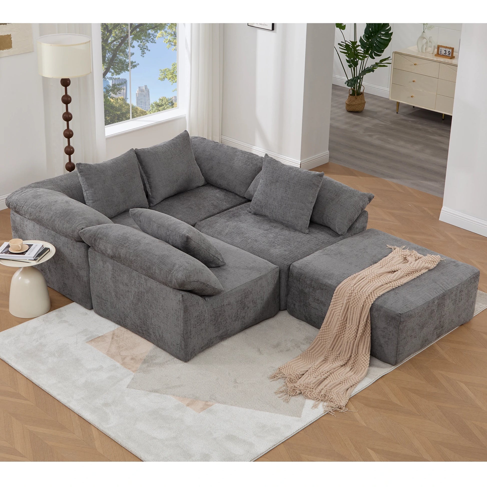 Graychenillemodularsectionalsofawithottomanstyledinamodernlivingroom