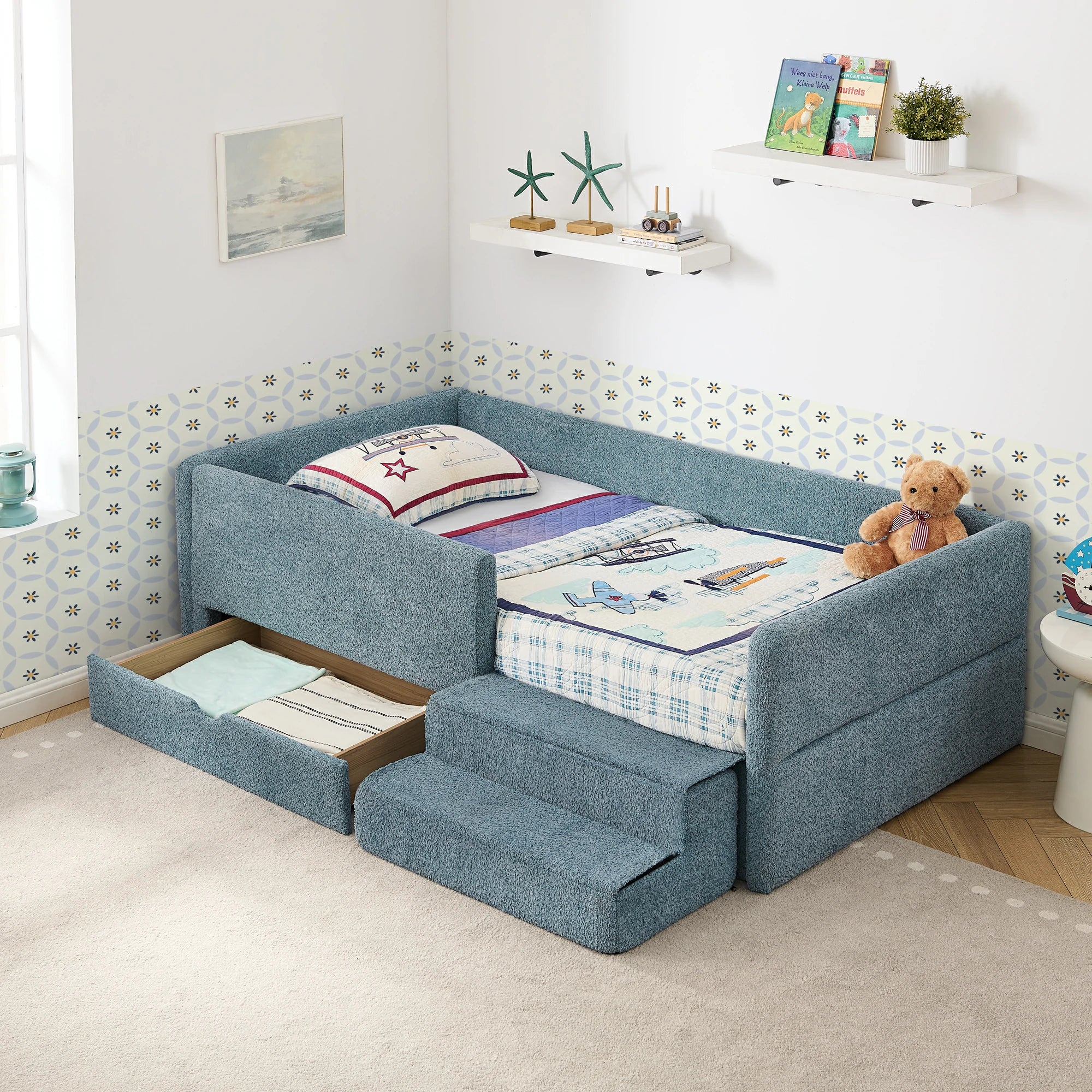 Softupholsteredkidsbedinbluebouclefabricfeaturingapull-outstoragedrawerandcushionedstepstool.Designedforsafety_comfort_andspace-savingfunctionality.